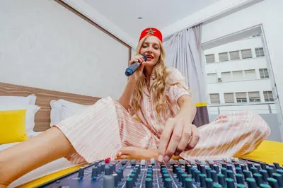 a woman sitting on a bed talking on a keyboard at Oum Palace Hotel & Spa in Casablanca