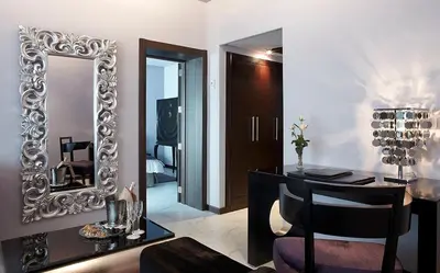 a room with a mirror and a desk with a chair at Avanti Mohammedia Hotel in Mohammedia