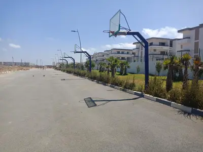an empty street with a basketball hoop at Marbella Beach Residency in Mansouria
