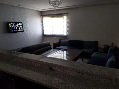 a living room with a couch and a table at Marbella Beach Residency in Mansouria