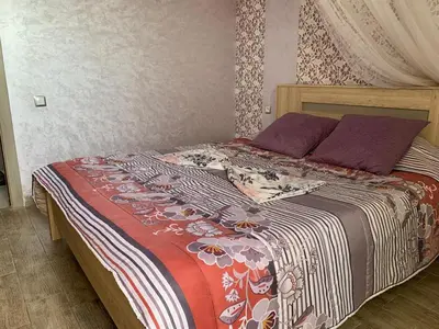 a bed with a colorful blanket and pillows on it at Marbella Beach Residency in Mansouria