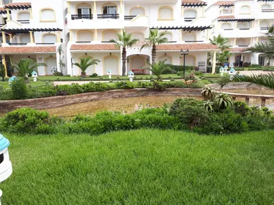 a large building with a lawn in front of it at Appartement Casablanca Garden Beach in Casablanca