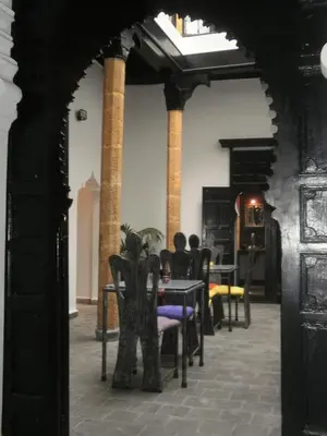 a room with chairs and a table and columns at Riad7 in Azemmour