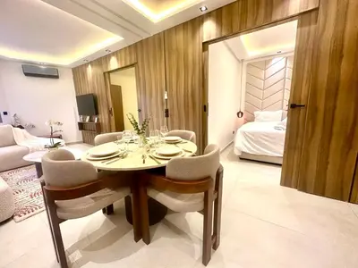 a dining room with a table and chairs and a bed at Calm&cosy appart very well located in Casablanca