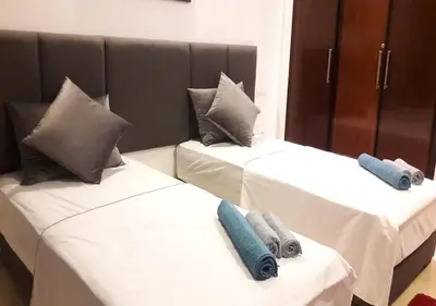 two beds with pillows on them in a room at Horizon Garden Home in Casablanca