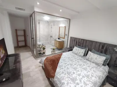 a bedroom with a large bed and a large mirror at appartments front mer in Bouznika