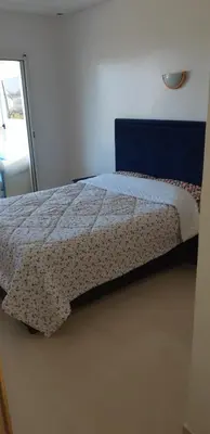 a bedroom with a bed with a quilt on it at Ola Blanca 1 in Dar Hamida