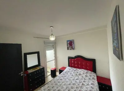 a bedroom with a bed with a mirror and a dresser at Appartement in Casablanca close to the beach in Casablanca