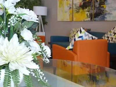 a living room with a glass table with white flowers at Relax Hotel Casa Voyageurs in Casablanca