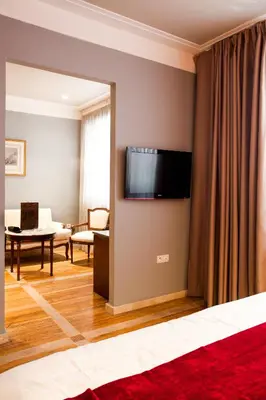 a living room with a flat screen tv on a wall at Hôtel Les Saisons in Casablanca