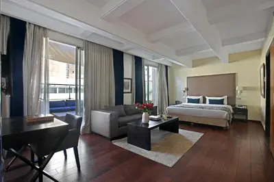 a large hotel room with a bed and a couch at Park Suites Hotel Luxury Boutique Hotel in Casablanca