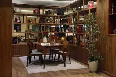 a dining room with a table and chairs and shelves at Park Suites Hotel Luxury Boutique Hotel in Casablanca