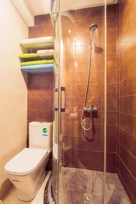 a bathroom with a toilet and a glass shower at Casablanca Home Stay Apartment in Casablanca
