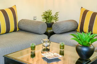 a living room with two couches and a coffee table at Manzil Hotel in Casablanca