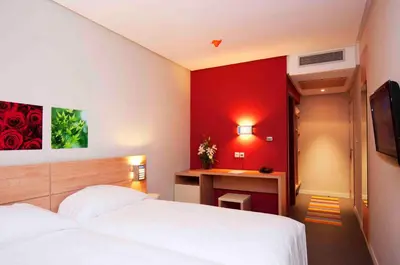 a hotel room with a bed and a desk at Manzil Hotel in Casablanca