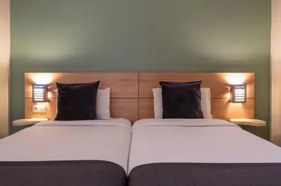 two beds in a room with two pillows at Manzil Hotel in Casablanca
