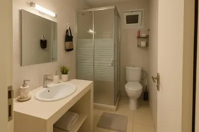 a bathroom with a sink and a toilet and a shower at Appartement Hay Riad in Rabat