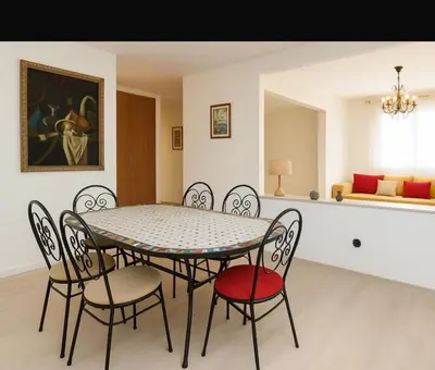 a dining room with a table and four chairs at Appartement Hay Riad in Rabat