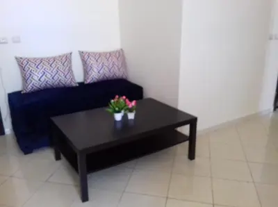 a black coffee table in a living room with a couch at Appartement Tamaris couple mariés in Tamaris