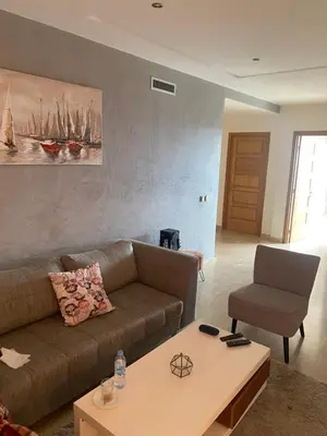 a living room with a couch and a coffee table at Résidence Evasion in Bouznika