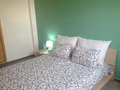 a bedroom with a bed with pillows on it at Familly Apartement Agdal Rabat centre in Rabat