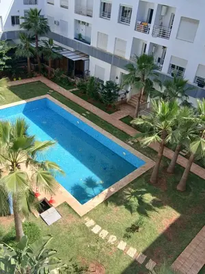 an overhead view of a swimming pool in front of a building at residance a 100 m de la mer in El Harhoura