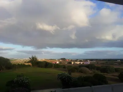 a view of a green field under a cloudy sky at Dar Al Manar in El Jadida