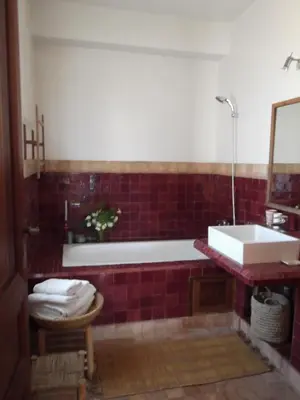 a bathroom with a bath tub and a sink at Dar Al Manar in El Jadida