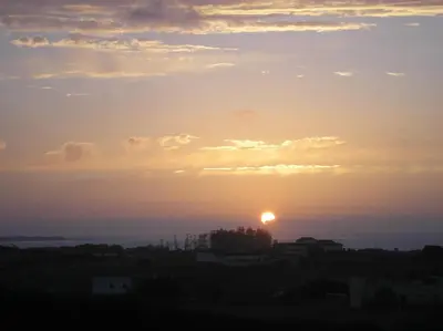 a sunset with the sun in the sky at Dar Al Manar in El Jadida