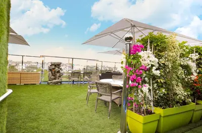 a patio with a table and some flowers and an umbrella at Suite Hotel Casa Diamond in Casablanca
