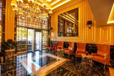 a lobby with a bar with chairs and a chandelier at Suite Hotel Casa Diamond in Casablanca