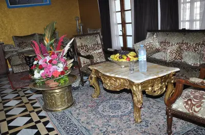 a living room with a table with a bowl of fruit at Hôtel Transatlantique in Casablanca
