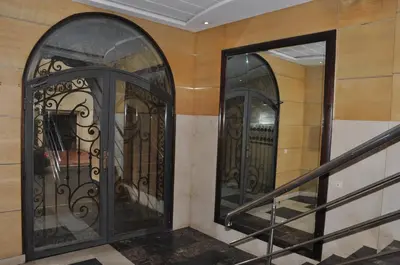 a pair of wrought iron doors in a hallway at Elegant Apartment with Balcony in Val Fleuri, Maarif Casablanca, Perfect for Family & Corporate Stays in Casablanca