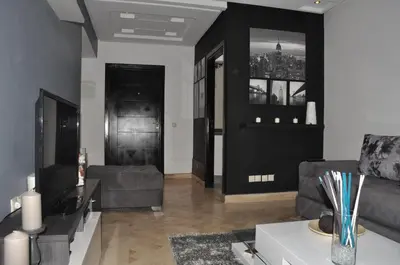 a living room with a couch and a tv at Elegant Apartment with Balcony in Val Fleuri, Maarif Casablanca, Perfect for Family & Corporate Stays in Casablanca