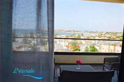 a room with a table and a window with a view at L'escale Suites Résidence Hôtelière By 7AV HOTELS in Mohammedia
