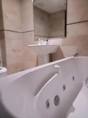 a bathroom with a white bath tub and a sink at Apartment with Terrace in Casablanca