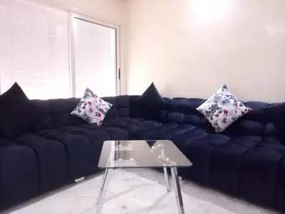 a living room with a blue couch with pillows on it at Apartment with Terrace in Casablanca