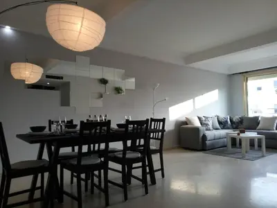 a dining room and living room with a table and chairs at Apartment with Terrace in Casablanca