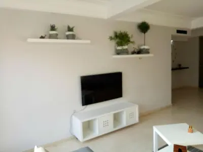 a living room with a flat screen tv on a white wall at Apartment with Terrace in Casablanca