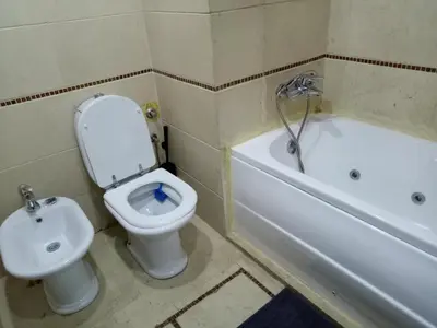a bathroom with a toilet and a tub and a sink at Apartment with Terrace in Casablanca