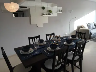 a dining room with a table with chairs and a couch at Apartment with Terrace in Casablanca