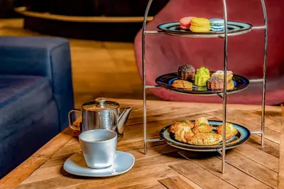 a table with two plates of food and a cup of coffee at Kyriad Residence Casablanca in Casablanca