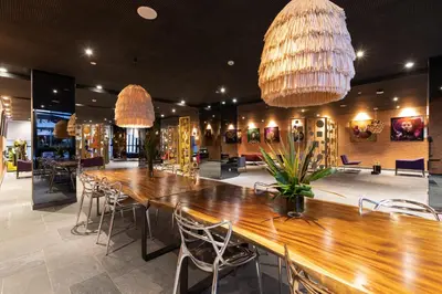 a restaurant with a long wooden table and chairs at ONOMO Hotel Casablanca City Center in Casablanca