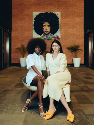 two women sitting on a chair in a room at ONOMO Hotel Casablanca City Center in Casablanca