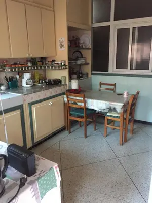 a kitchen with a table and chairs in it at Property in a quiet area close to the train station and town in Casablanca