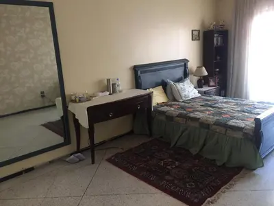 a bedroom with a bed and a desk and a mirror at Property in a quiet area close to the train station and town in Casablanca