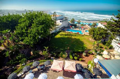 an aerial view of a resort with a pool and the ocean at Hotel Bellerive in Casablanca