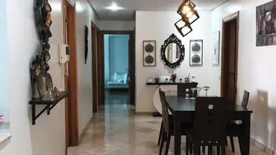 a dining room with a black table and chairs at home zen in Rabat