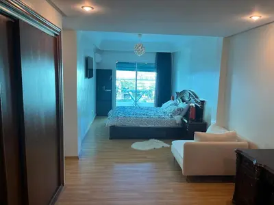 a bedroom with a bed and a couch and a window at home zen in Rabat