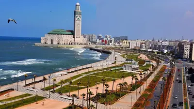a city with a clock tower next to the ocean at Appartement Casablanca vue sur mer in Casablanca
